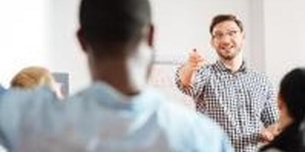 Participant and instructor interacting in a classroom